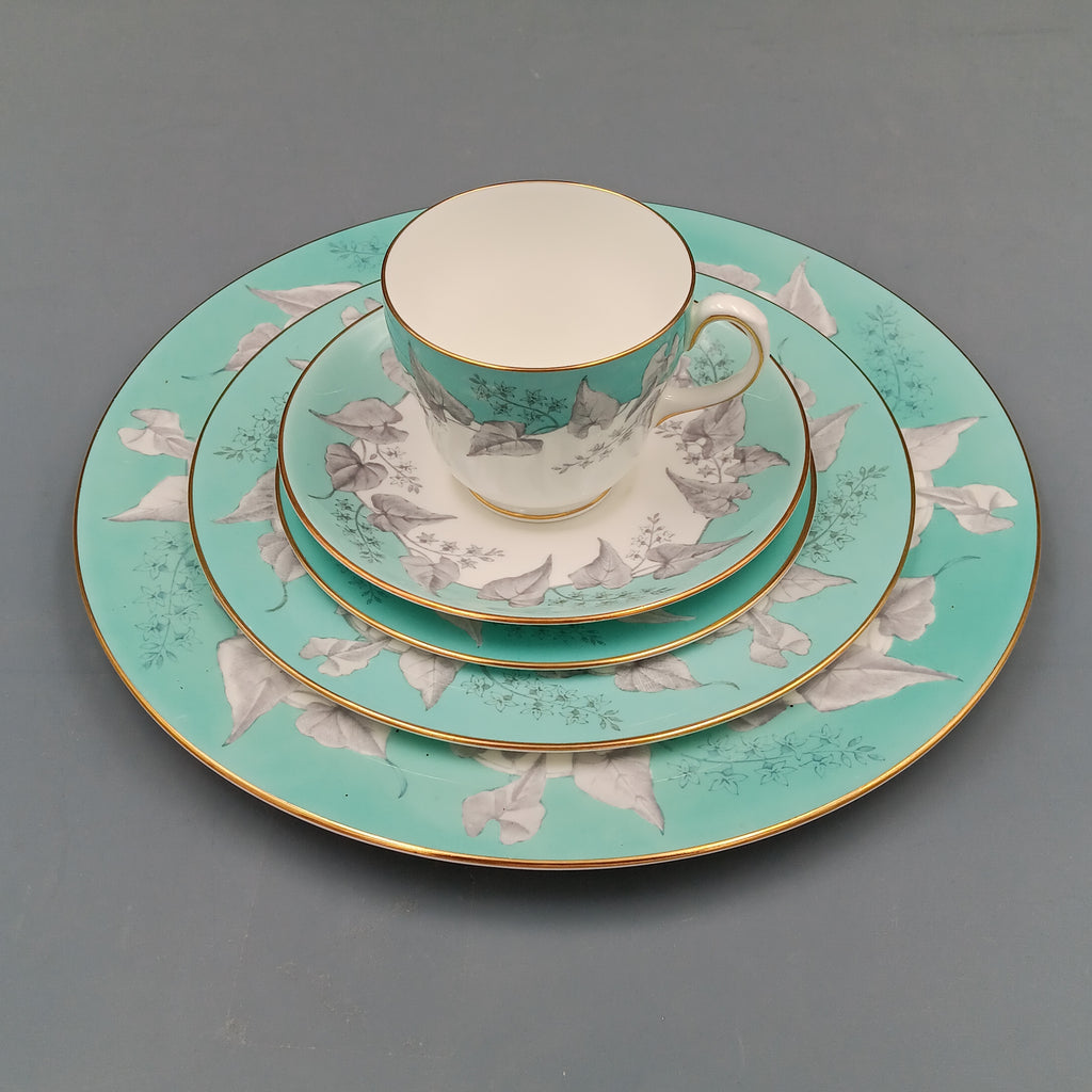 Wedgwood 'Buxton Turquoise' 5-piece vintage dinnerware set featuring a teacup, saucer, and three plates with turquoise floral borders, gold rims, and white porcelain centers.