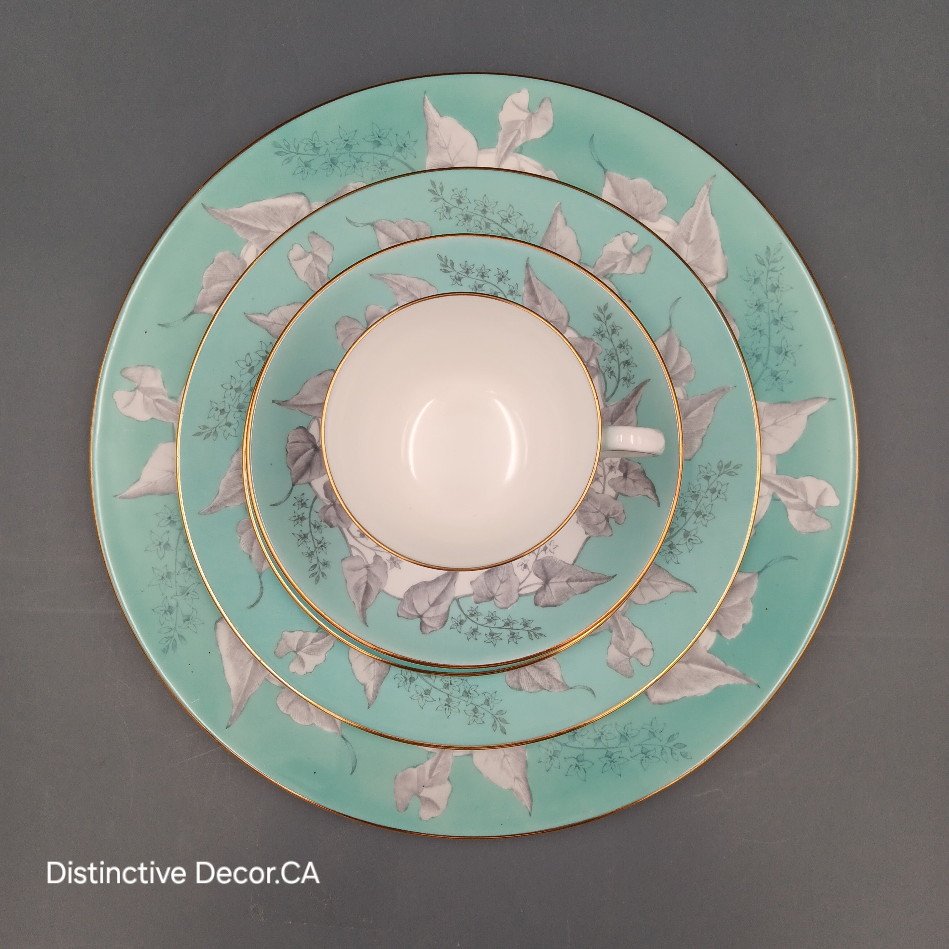 Wedgwood 'Buxton Turquoise' 5-piece vintage dinnerware set featuring a teacup, saucer, and three plates with turquoise floral borders, gold rims, and white porcelain centers.