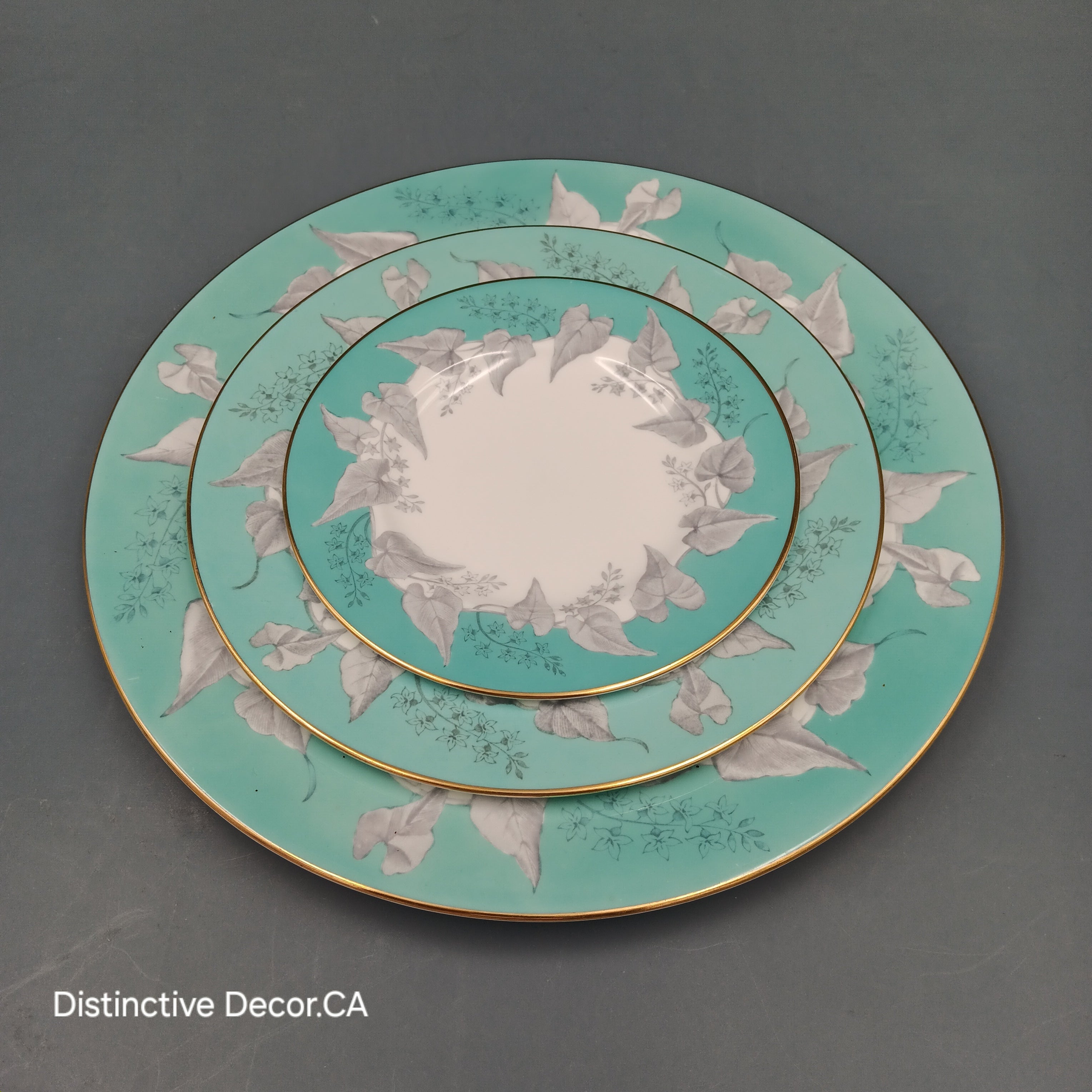 Wedgwood 'Buxton Turquoise' 5-piece vintage dinnerware set featuring a teacup, saucer, and three plates with turquoise floral borders, gold rims, and white porcelain centers.