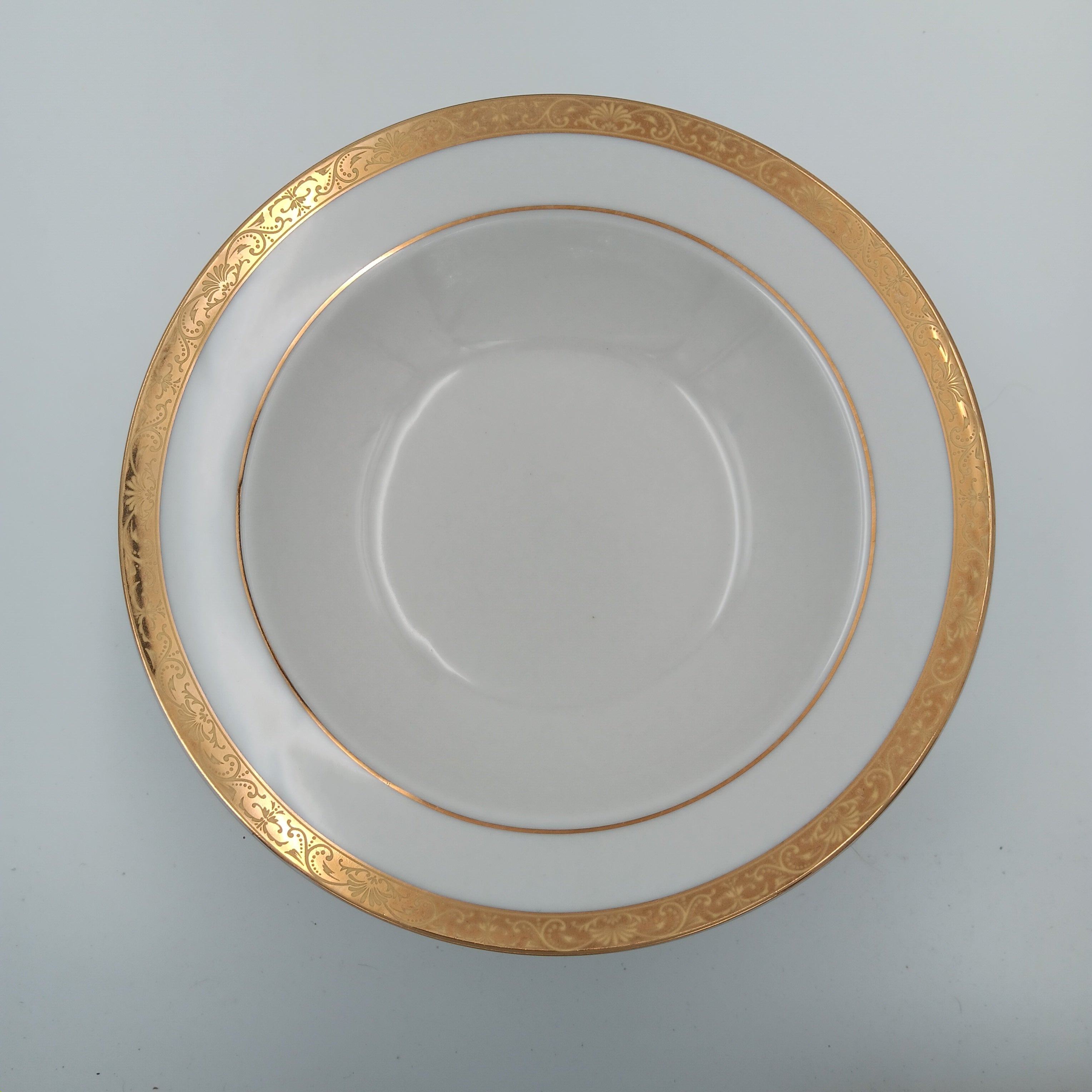 Gold-rimmed porcelain soup bowl from formal dinnerware collection